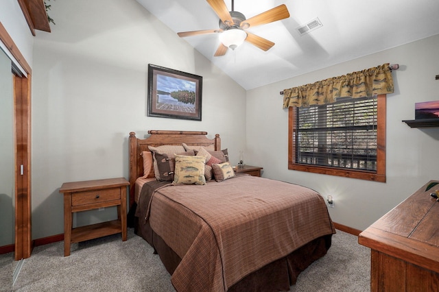 bedroom with vaulted ceiling, baseboards, visible vents, and light carpet