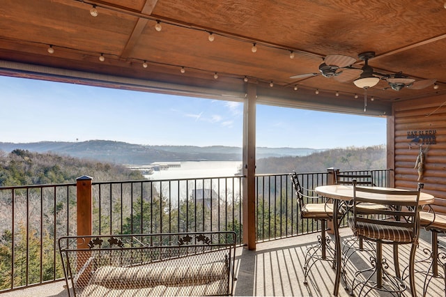 balcony with a mountain view and ceiling fan