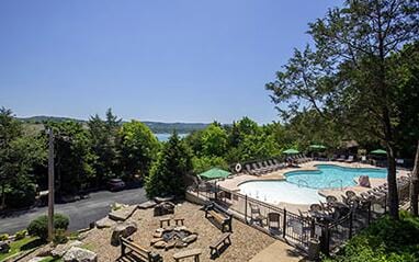 pool with a patio and fence