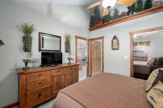 bedroom featuring ceiling fan and a towering ceiling