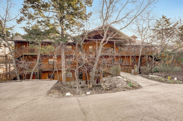 view of front of house with stairs and driveway