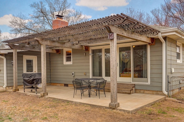 back of house featuring a chimney, crawl space, a pergola, and a patio