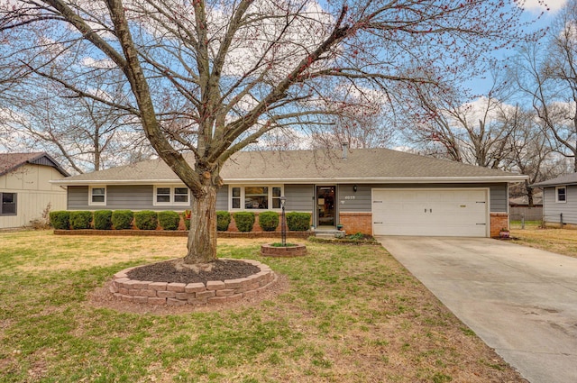 ranch-style house featuring brick siding, an attached garage, concrete driveway, and a front yard