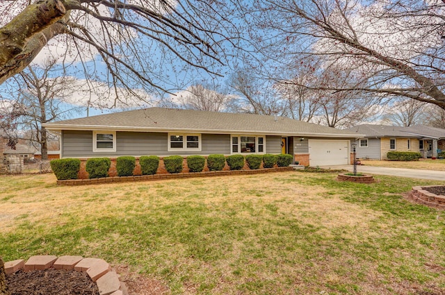 ranch-style home with brick siding, an attached garage, driveway, and a front lawn