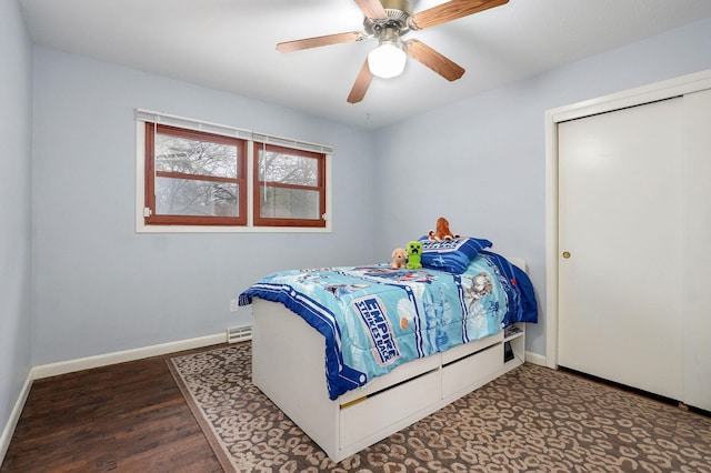 bedroom with ceiling fan, visible vents, baseboards, and wood finished floors