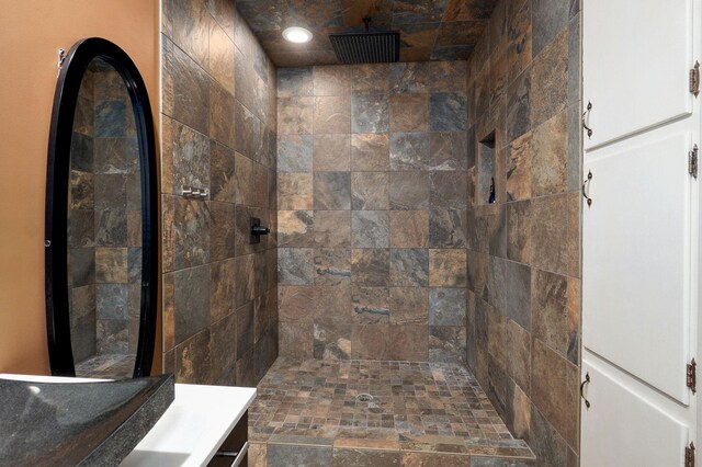 full bath with a sink, recessed lighting, and tiled shower