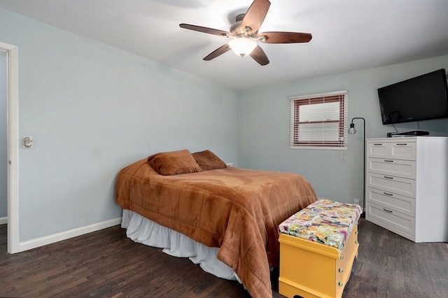 bedroom with a ceiling fan, dark wood-style floors, and baseboards