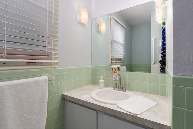 bathroom with tile walls, wainscoting, and vanity