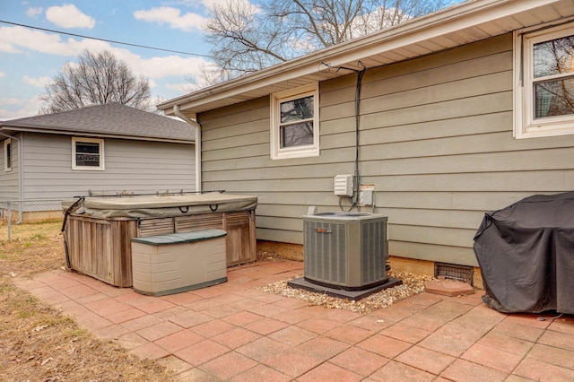 view of patio / terrace featuring cooling unit and a hot tub