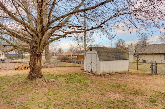 view of yard featuring an outbuilding, a shed, and a fenced backyard