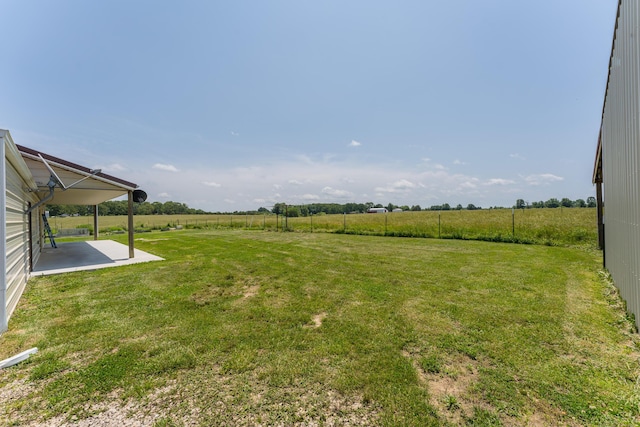 view of yard with a patio area and a rural view