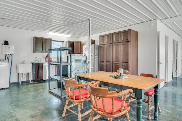 dining area featuring finished concrete floors and washer / clothes dryer