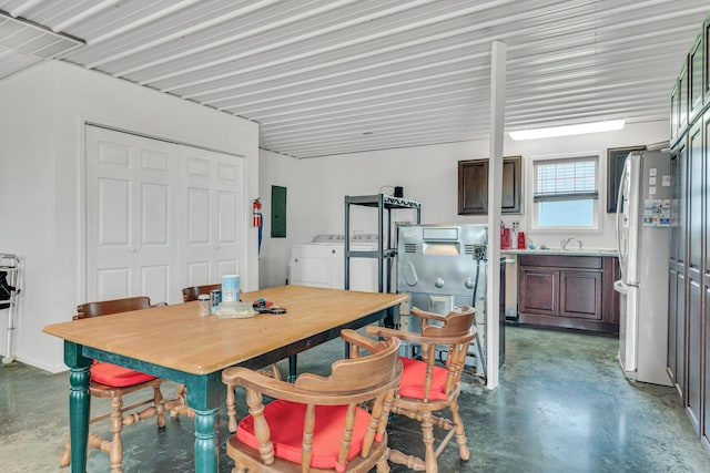dining room with finished concrete flooring and separate washer and dryer