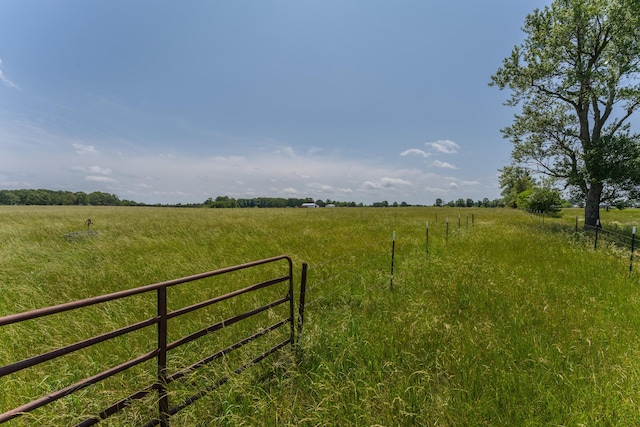 view of yard featuring a rural view and fence