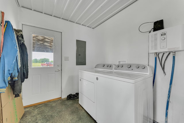 washroom featuring electric panel, laundry area, and washer and dryer