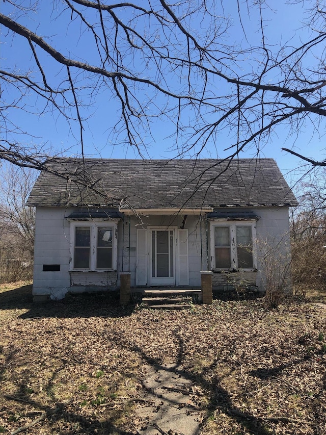 view of front of house with covered porch and roof with shingles