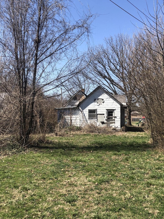 exterior space with a lawn and a chimney