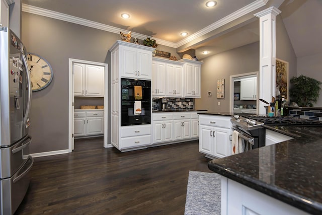 kitchen featuring decorative backsplash, white cabinetry, stainless steel appliances, and dark wood-type flooring