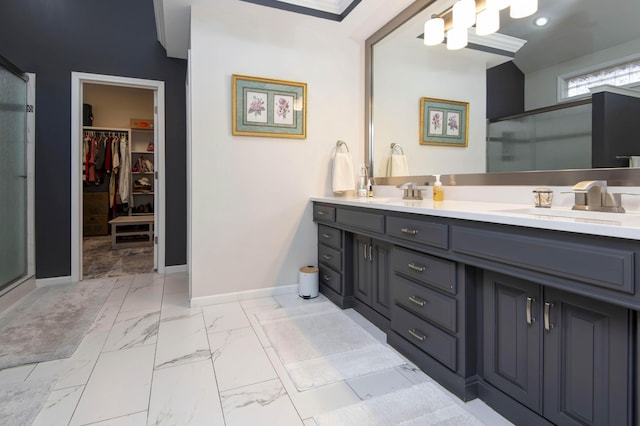 bathroom with a shower stall, baseboards, marble finish floor, and a sink