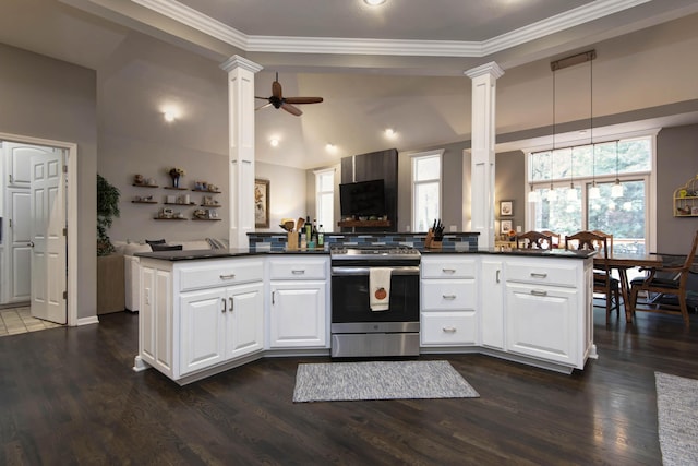 kitchen featuring ornate columns, dark wood finished floors, electric range, ceiling fan, and dark countertops