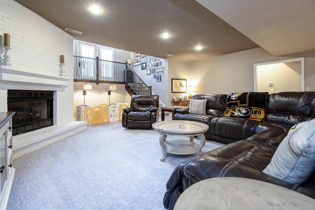 living room with stairway, visible vents, recessed lighting, a fireplace, and carpet flooring