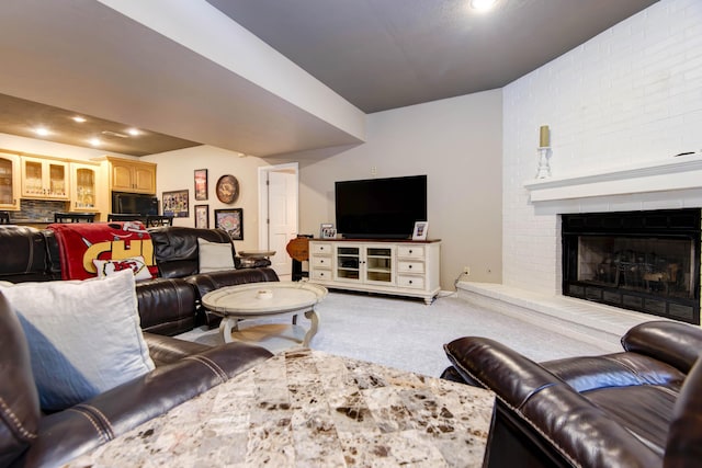 living room featuring baseboards, light carpet, and a brick fireplace