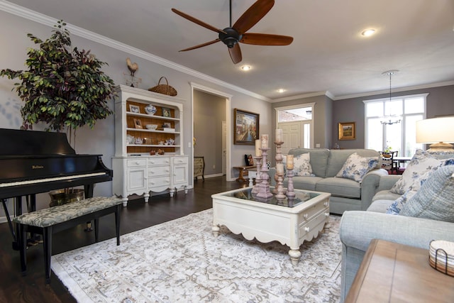 living room featuring recessed lighting, ceiling fan with notable chandelier, crown molding, and dark wood-type flooring