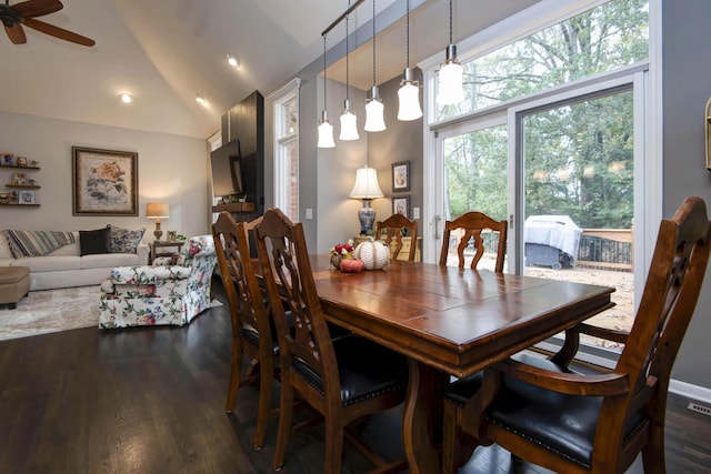 dining room featuring visible vents, a ceiling fan, lofted ceiling, and wood finished floors