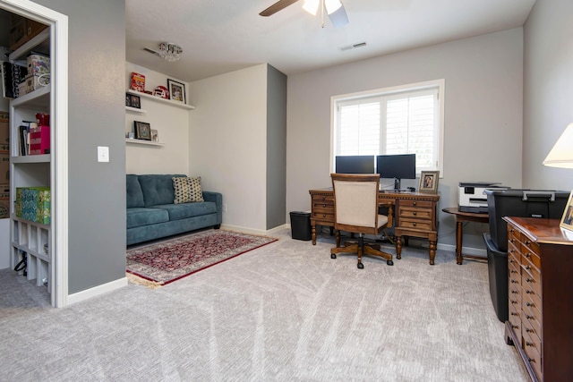 office space featuring a ceiling fan, baseboards, visible vents, and carpet floors