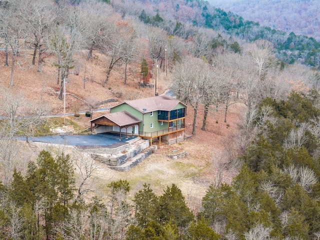 birds eye view of property featuring a view of trees