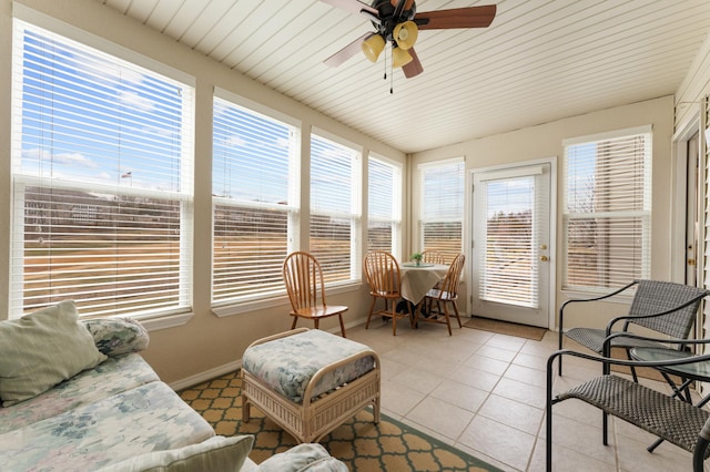 sunroom / solarium featuring a healthy amount of sunlight and ceiling fan