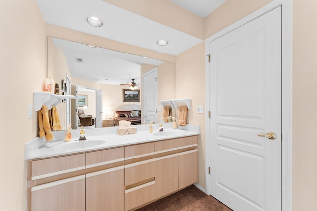 bathroom featuring a sink, a ceiling fan, double vanity, and ensuite bathroom