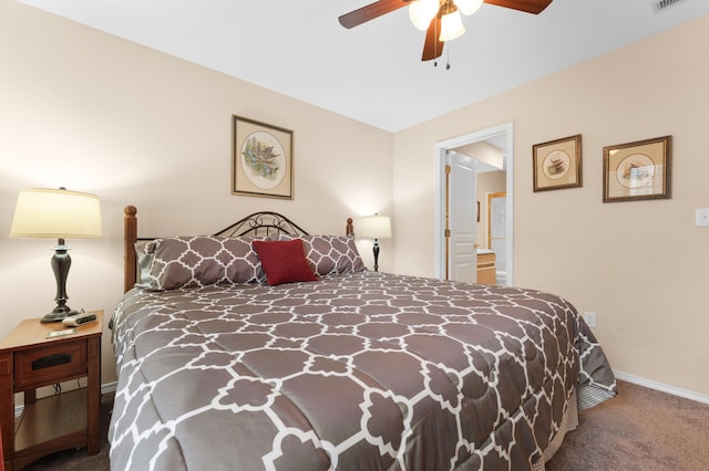 bedroom with a ceiling fan, visible vents, baseboards, carpet floors, and ensuite bathroom