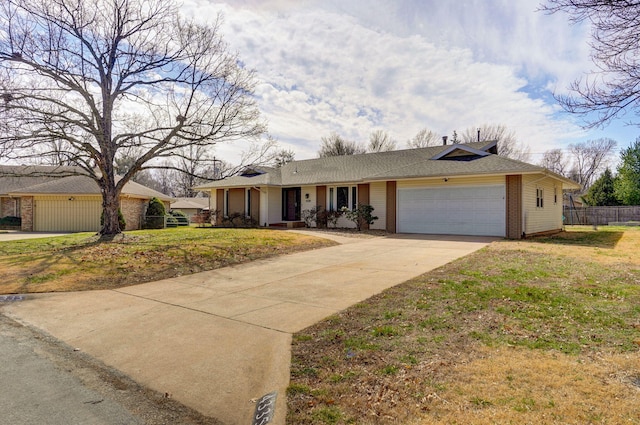 single story home featuring brick siding, fence, concrete driveway, a front yard, and an attached garage