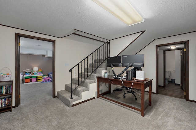 home office with a textured ceiling and carpet