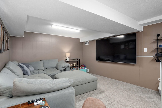 carpeted living room with visible vents and a textured ceiling