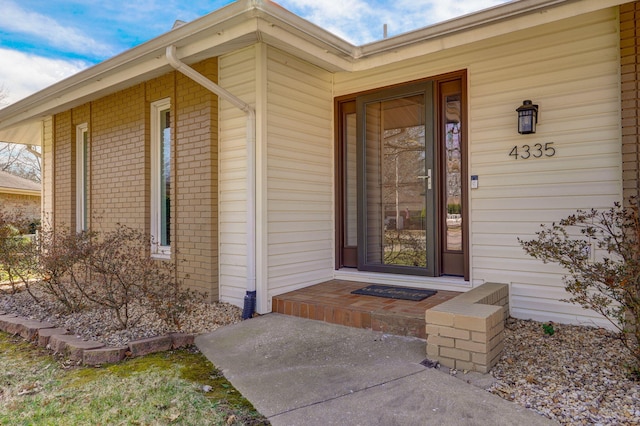 property entrance with brick siding