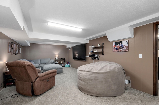 carpeted living room featuring a textured ceiling