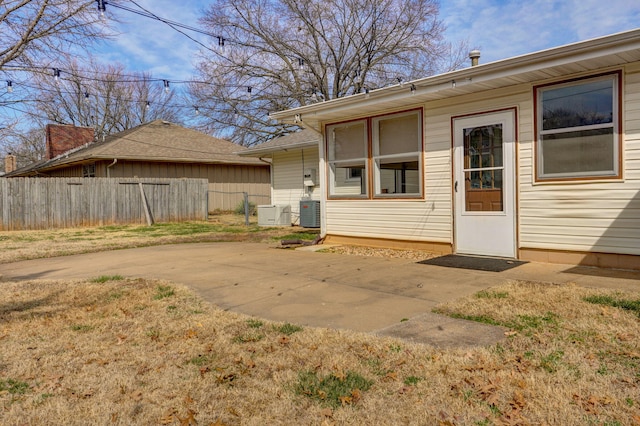 back of property with a patio area, central AC unit, and fence