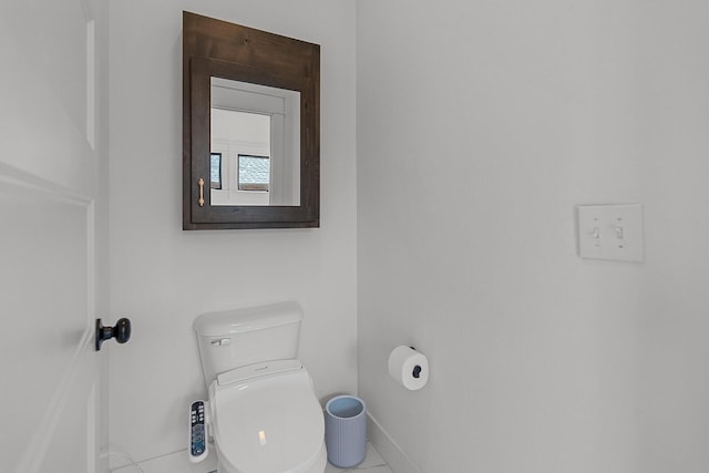 bathroom featuring toilet and baseboards