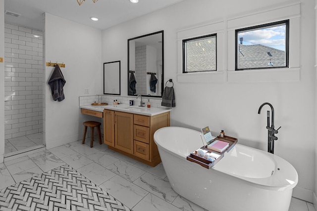 bathroom with a sink, visible vents, plenty of natural light, and marble finish floor