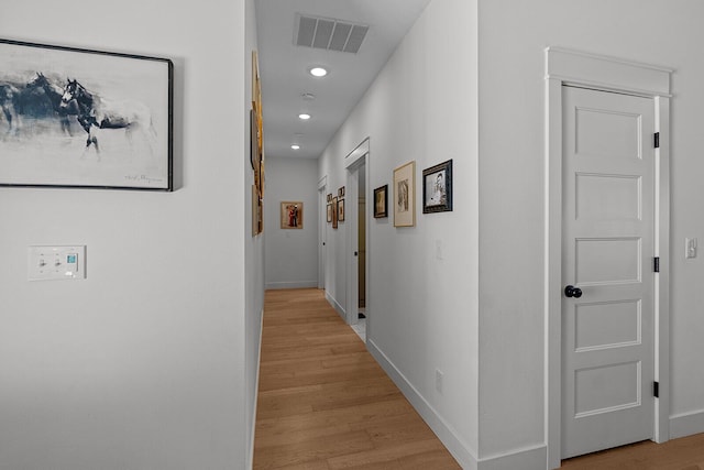 corridor with recessed lighting, light wood-style floors, visible vents, and baseboards