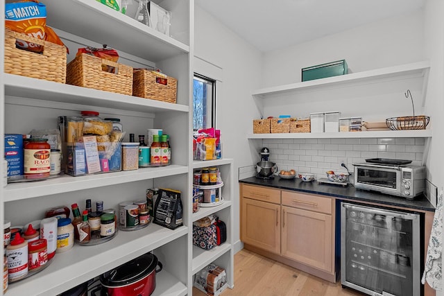 pantry with wine cooler and a toaster