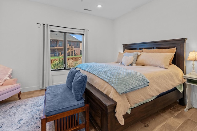 bedroom featuring visible vents, recessed lighting, baseboards, and wood finished floors