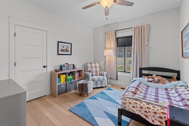 bedroom featuring light wood finished floors and ceiling fan