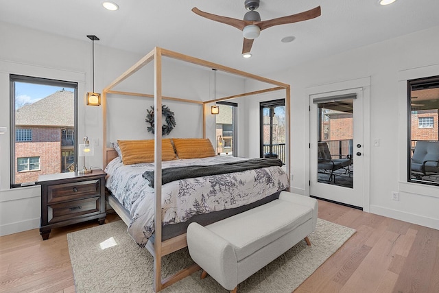 bedroom featuring access to outside, multiple windows, light wood-style floors, and recessed lighting