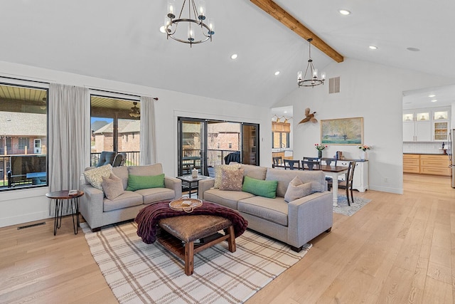 living area with beamed ceiling, light wood-style floors, visible vents, and a chandelier