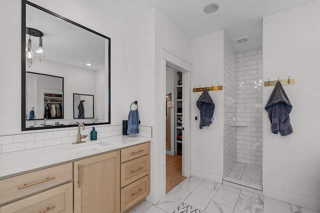 full bath with vanity, visible vents, decorative backsplash, walk in shower, and marble finish floor