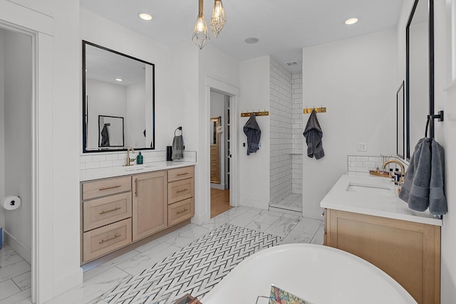 bathroom with backsplash, a freestanding bath, tiled shower, marble finish floor, and vanity