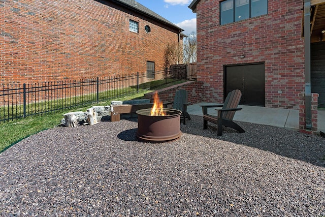 view of patio featuring fence and an outdoor fire pit